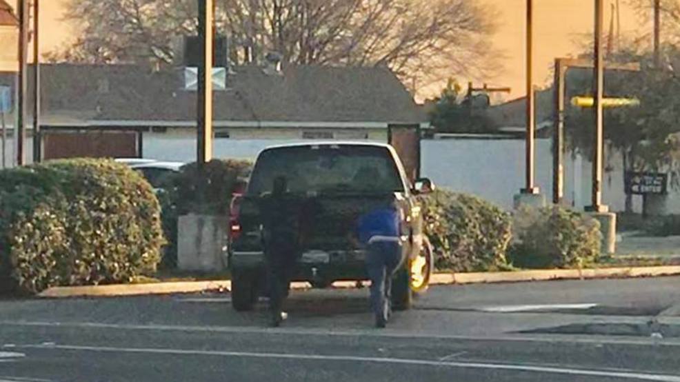Kingsburg Police Officer helps push stranded motorist's truck out of